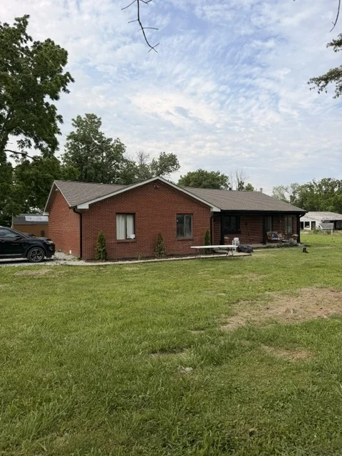 Red brick ranch home with a new shingle roof