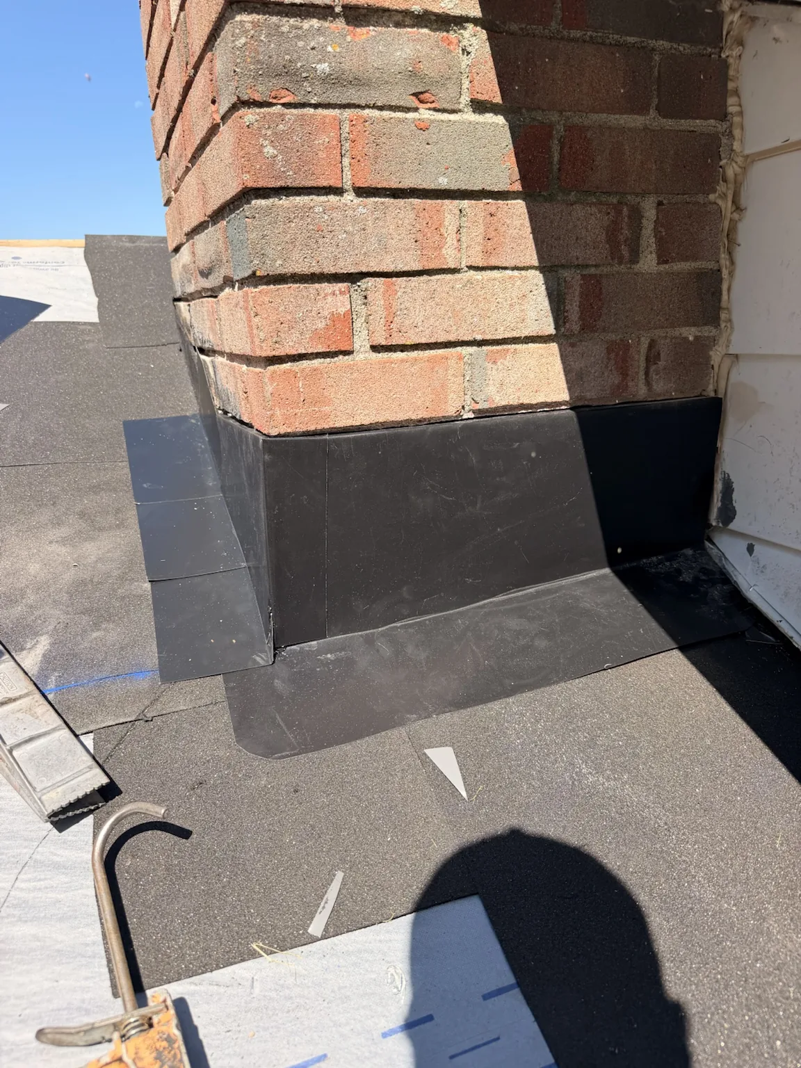 Chimney flashing detail during roofing work